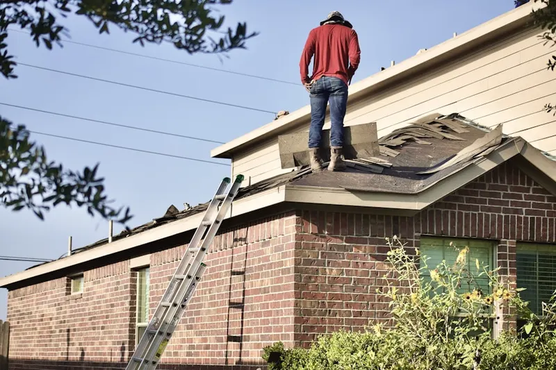Professional roofer working on a residential roof in Chateau Bayonne